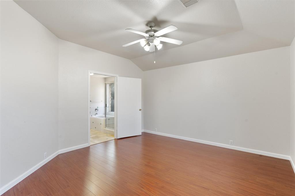 902 Rocking Spur Cove Pflugerville, TX 78660 - Photo 11 of 21 a view of an empty room with wooden floor