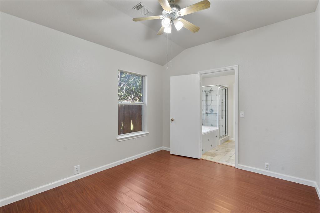 902 Rocking Spur Cove Pflugerville, TX 78660 - Photo 13 of 21 an empty room with wooden floor closet and windows