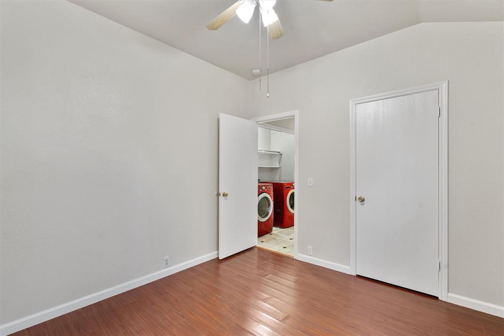 902 Rocking Spur Cove Pflugerville, TX 78660 - Photo 14 of 21 a view of a room with wooden floor and a ceiling fan
