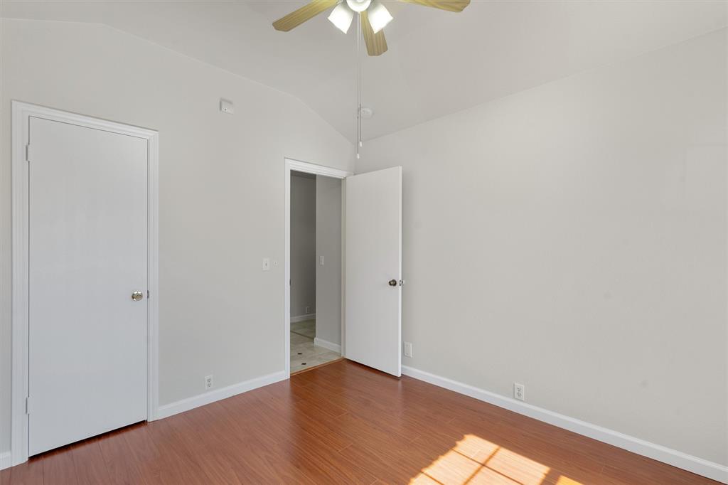 902 Rocking Spur Cove Pflugerville, TX 78660 - Photo 15 of 21 a view of an empty room with wooden floor and a chandelier fan