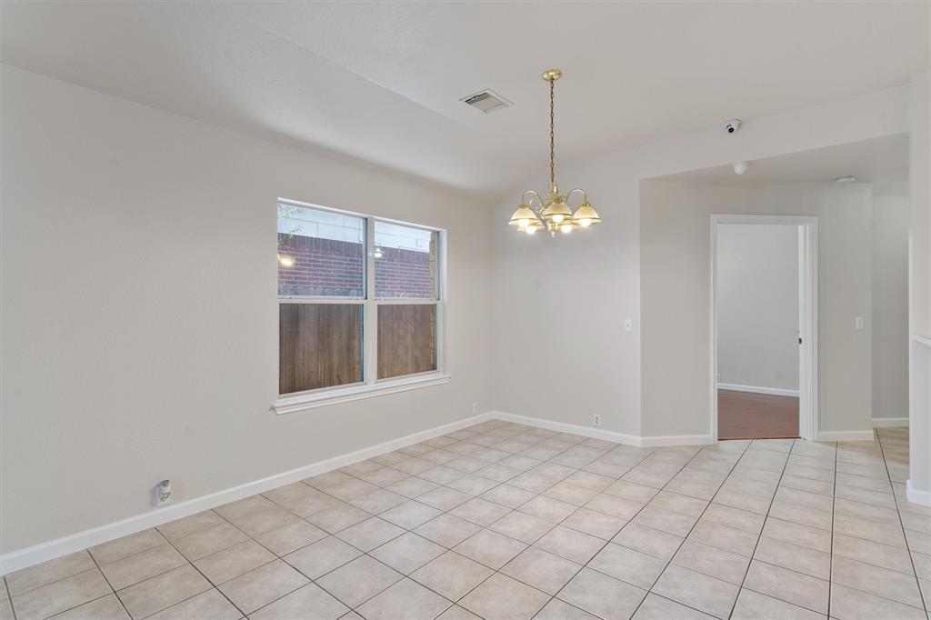 902 Rocking Spur Cove Pflugerville, TX 78660 - Photo 5 of 21 a view of an empty room with window and chandelier fan