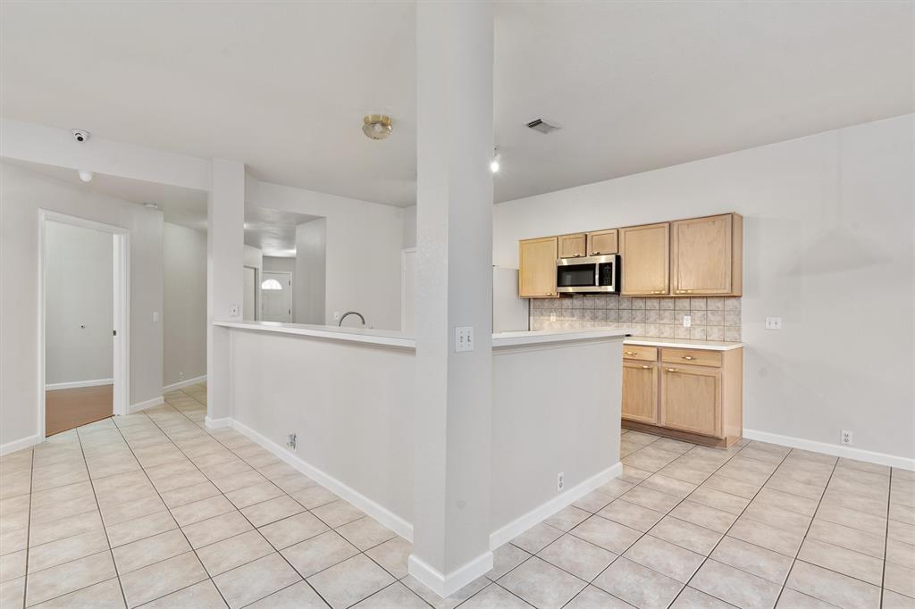 902 Rocking Spur Cove Pflugerville, TX 78660 - Photo 6 of 21 a view of a kitchen with white cabinets