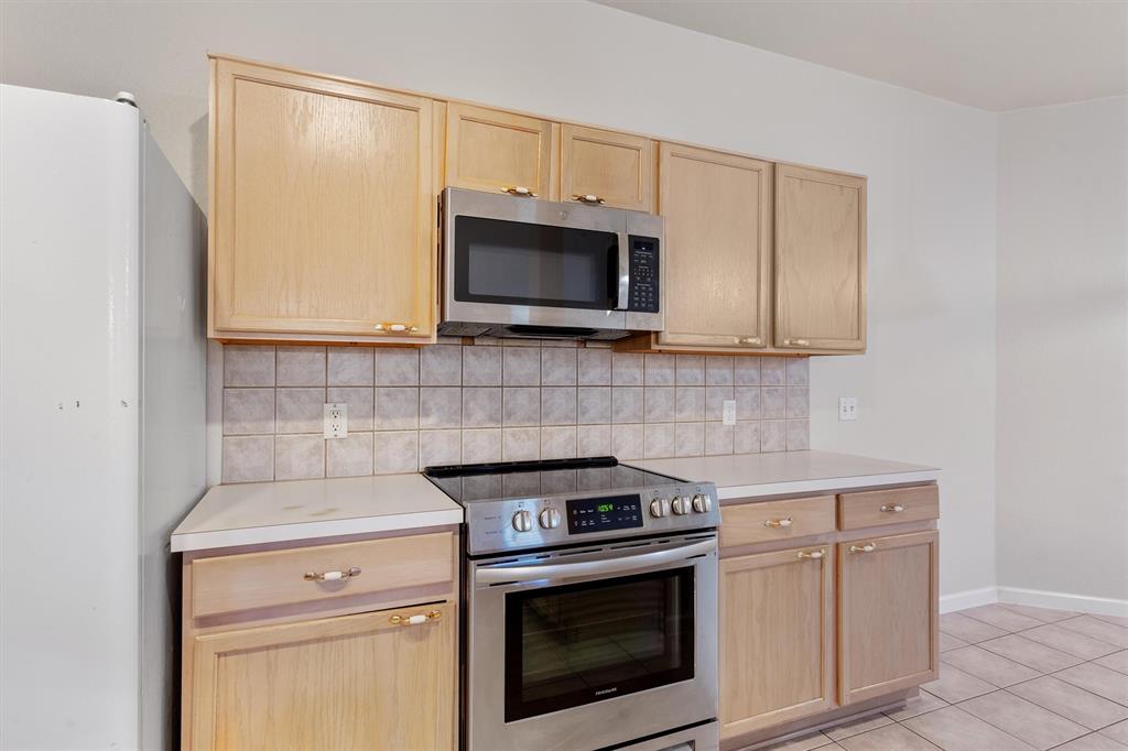 902 Rocking Spur Cove Pflugerville, TX 78660 - Photo 7 of 21 a kitchen with granite countertop white cabinets stainless steel appliances and a counter space