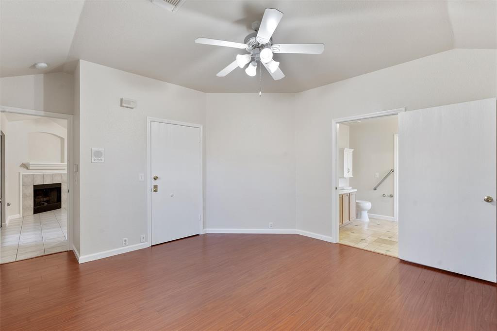 902 Rocking Spur Cove Pflugerville, TX 78660 - Photo 9 of 21 wooden floor in an empty room with a fireplace