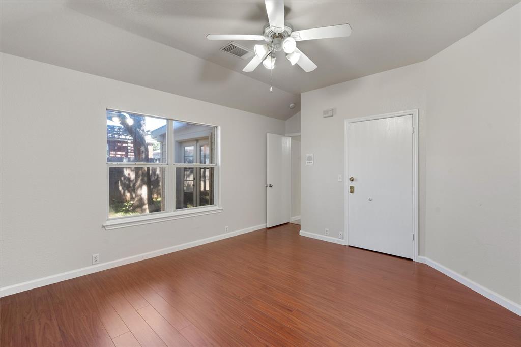 902 Rocking Spur Cove Pflugerville, TX 78660 - Photo 10 of 21 wooden floor in an empty room with a window