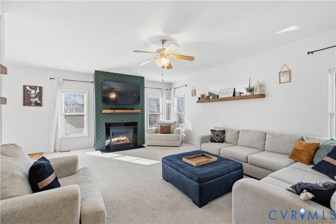 940 Gorham Court Midlothian, VA 23114 - Photo 12 of 45 a living room with furniture a fireplace and a flat screen tv
