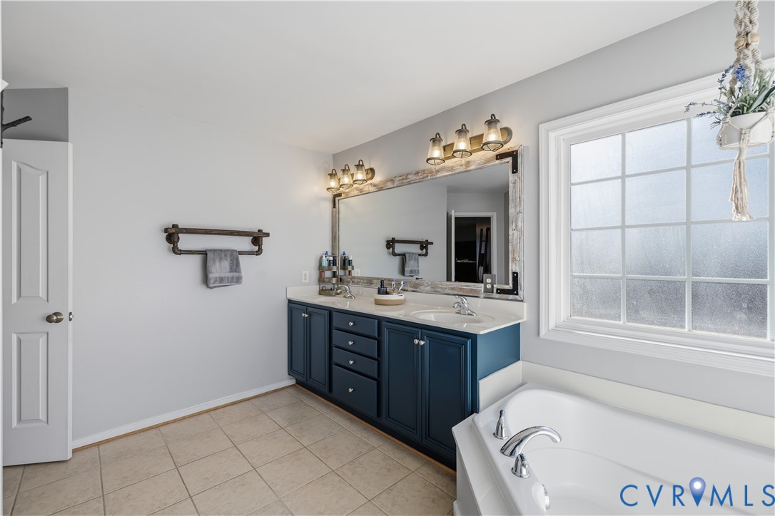 940 Gorham Court Midlothian, VA 23114 - Photo 26 of 45 a spacious bathroom with a tub sink and mirror