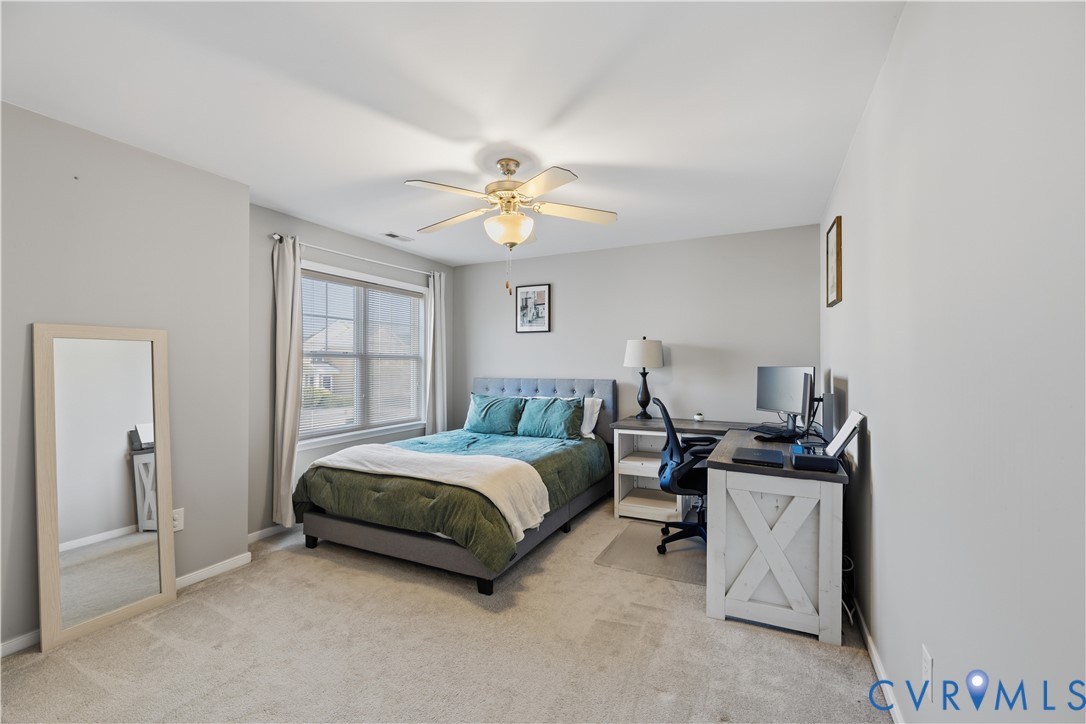 940 Gorham Court Midlothian, VA 23114 - Photo 28 of 45 a bedroom with a bed and a chandelier