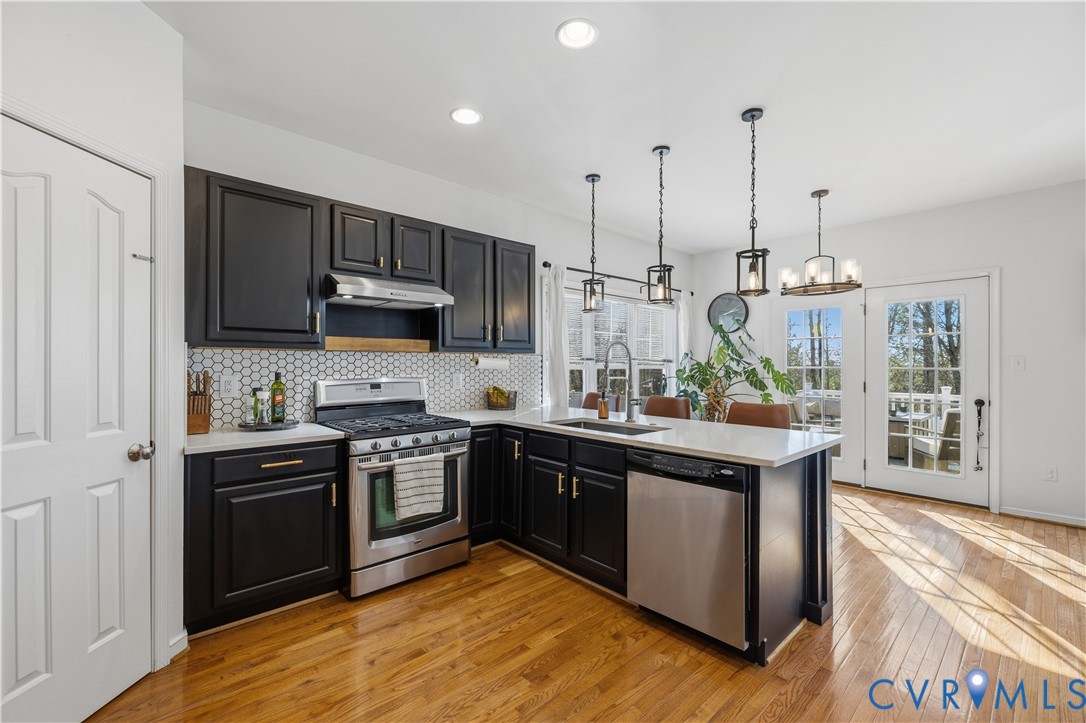 940 Gorham Court Midlothian, VA 23114 - Photo 5 of 45 a kitchen with stainless steel appliances granite countertop a stove a sink and a refrigerator