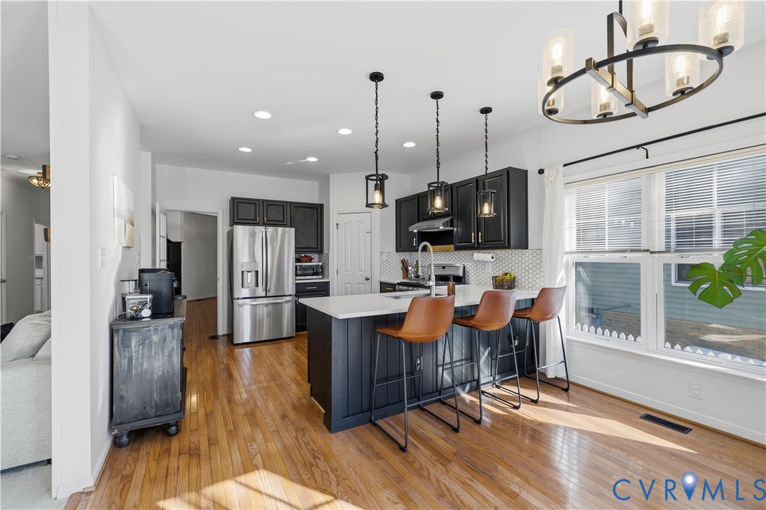 940 Gorham Court Midlothian, VA 23114 - Photo 7 of 45 a living room with furniture a dining table and chairs with wooden floor