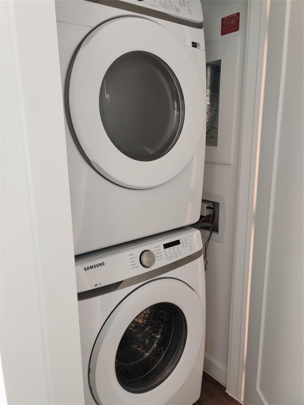 4801 Springdale Road, Unit 1102 Austin, TX 78723 - Photo 10 of 18 Stacked laundry appliances tucked neatly into a functional laundry closet.