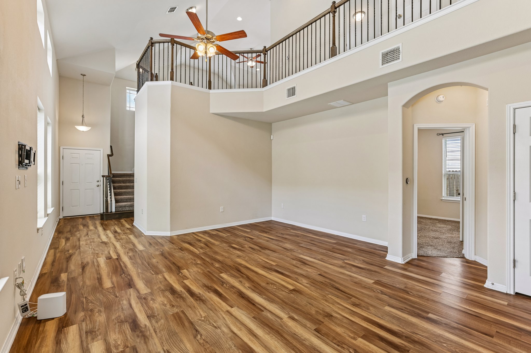 808 Totis Road Austin, TX 78748 - Photo 5 of 40 Spacious living area featuring wood-finish flooring, vaulted ceilings, and an open loft overlook