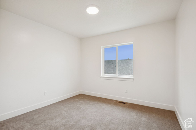 1615 North Angel Street, Unit F Layton, UT 84041 - Photo 11 of 45 Carpeted spare room with baseboards
