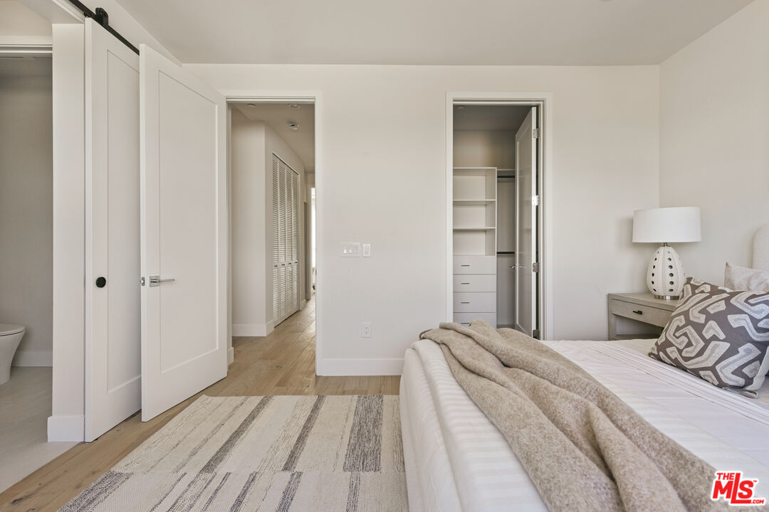 3220 South Barrington Avenue Los Angeles, CA 90066 - Photo 12 of 30 a bedroom with a bed and wooden floor