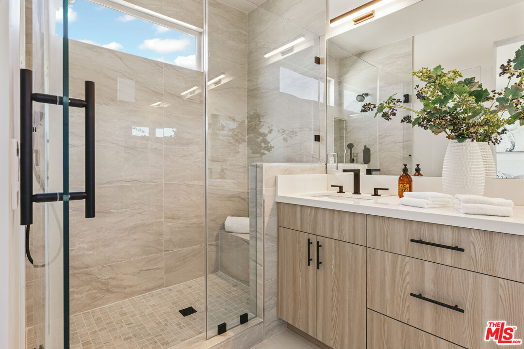 3220 South Barrington Avenue Los Angeles, CA 90066 - Photo 14 of 30 a bathroom with a shower sink and mirror
