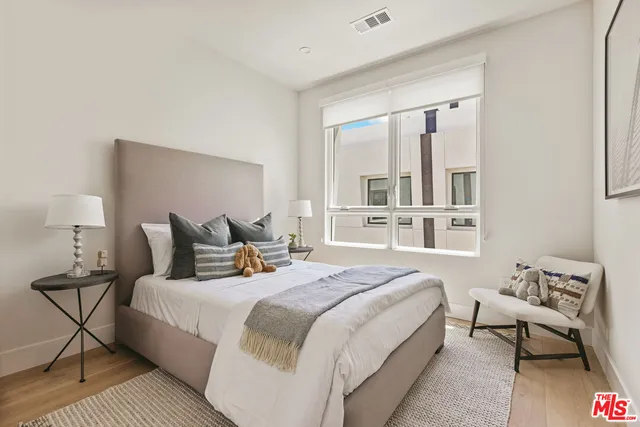 a bedroom with bed and a window