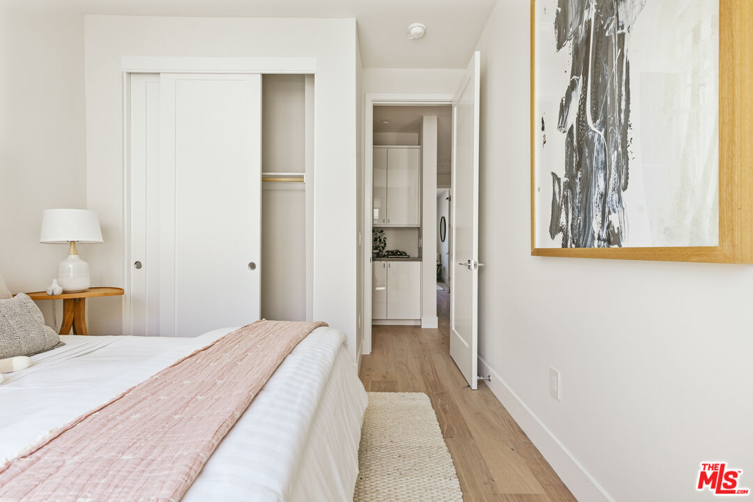 3220 South Barrington Avenue Los Angeles, CA 90066 - Photo 18 of 30 a bedroom with a bed and a painting on the wall