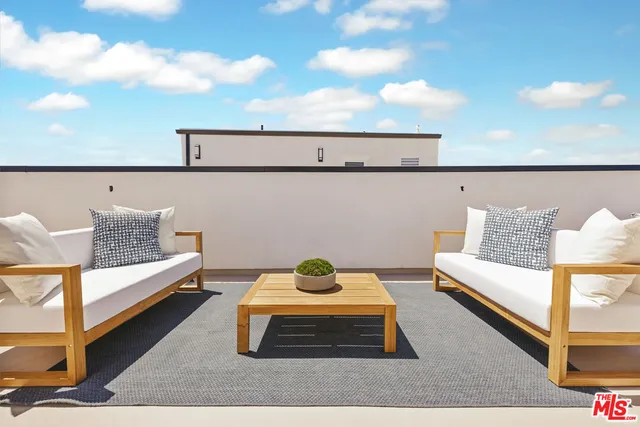 a living room with furniture and a night stand