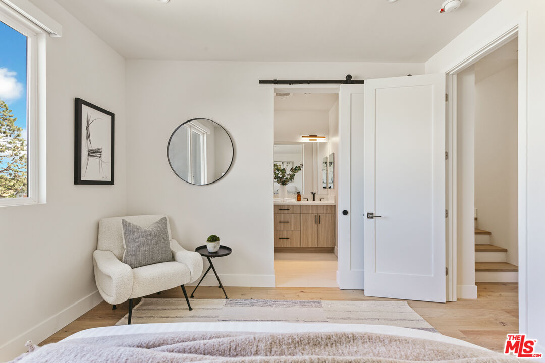 3220 South Barrington Avenue Los Angeles, CA 90066 - Photo 23 of 30 a living room with furniture a mirror and a window