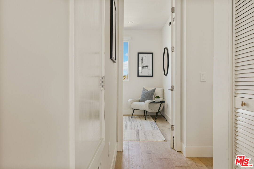 3220 South Barrington Avenue Los Angeles, CA 90066 - Photo 24 of 30 a living room with furniture and a painting on the wall