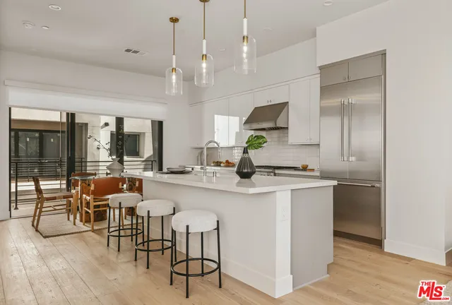 a large kitchen with a table and chairs