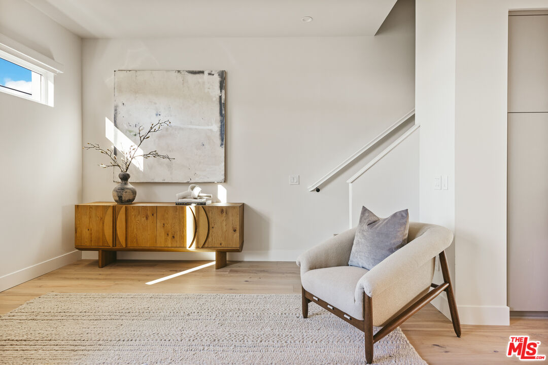 3220 South Barrington Avenue Los Angeles, CA 90066 - Photo 6 of 30 a living room with furniture and a wall