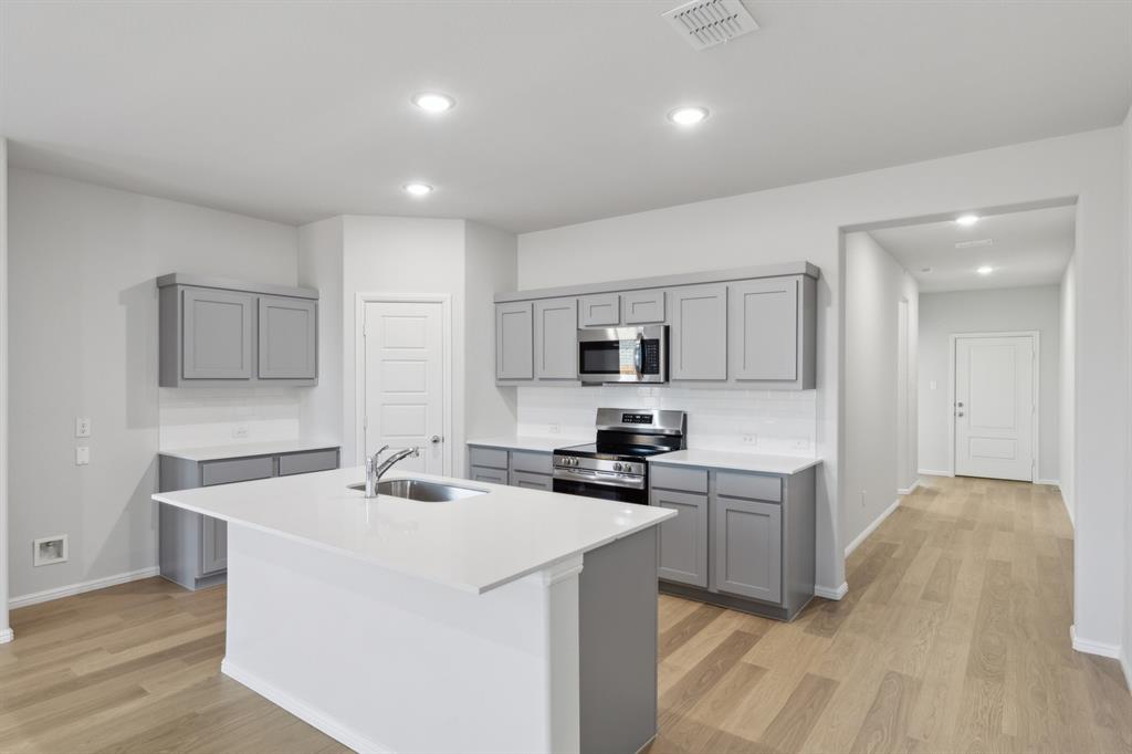 1161 Del Rio Drive Lavon, TX 75166 - Photo 6 of 38 Kitchen in the Holden home plan by Trophy Signature Homes – REPRESENTATIVE PHOTO