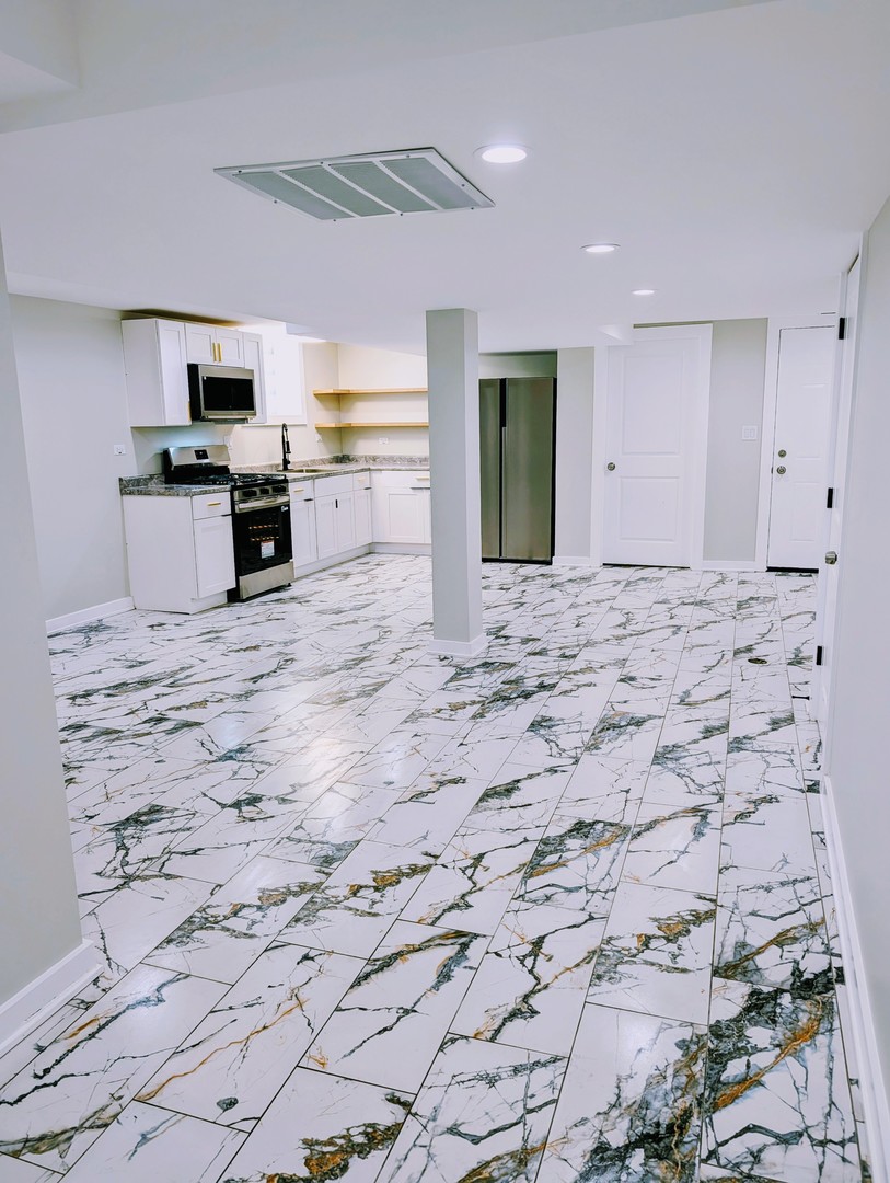 41 West 14th Place, Unit B Chicago Heights, IL 60411 - Photo 7 of 16 a view of a kitchen with microwave and cabinets