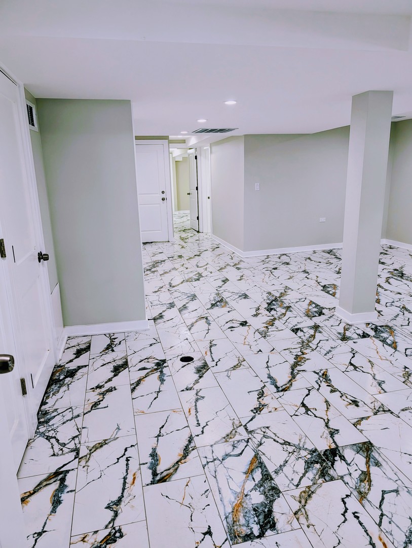 41 West 14th Place, Unit B Chicago Heights, IL 60411 - Photo 8 of 16 a large bedroom with a bed