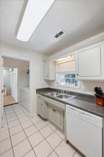 a kitchen with stainless steel appliances granite countertop a sink and cabinets