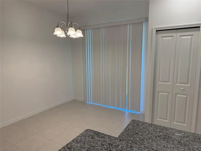 a view of a chandelier in big room and closet