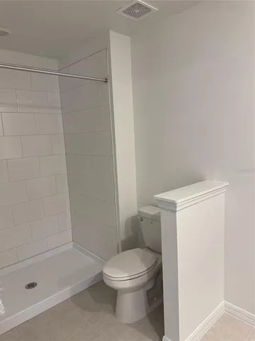 a bathroom with a toilet and shower