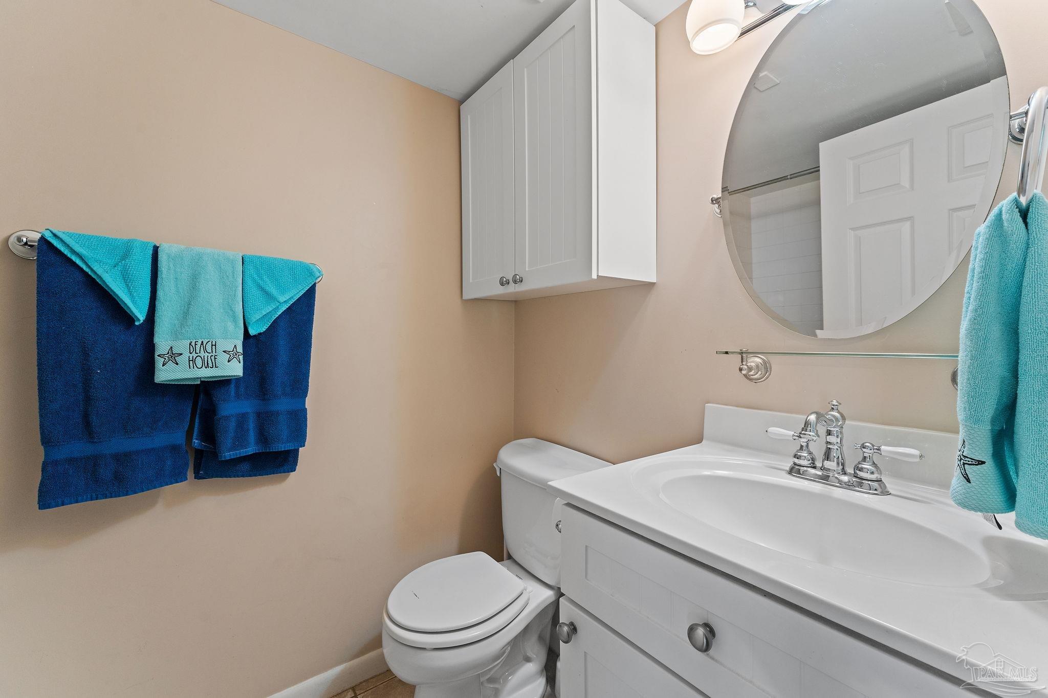 14623 Perdido Key Drive, Unit W106 Perdido Key, FL 32507 - Photo 12 of 50 a bathroom with a toilet sink and mirror