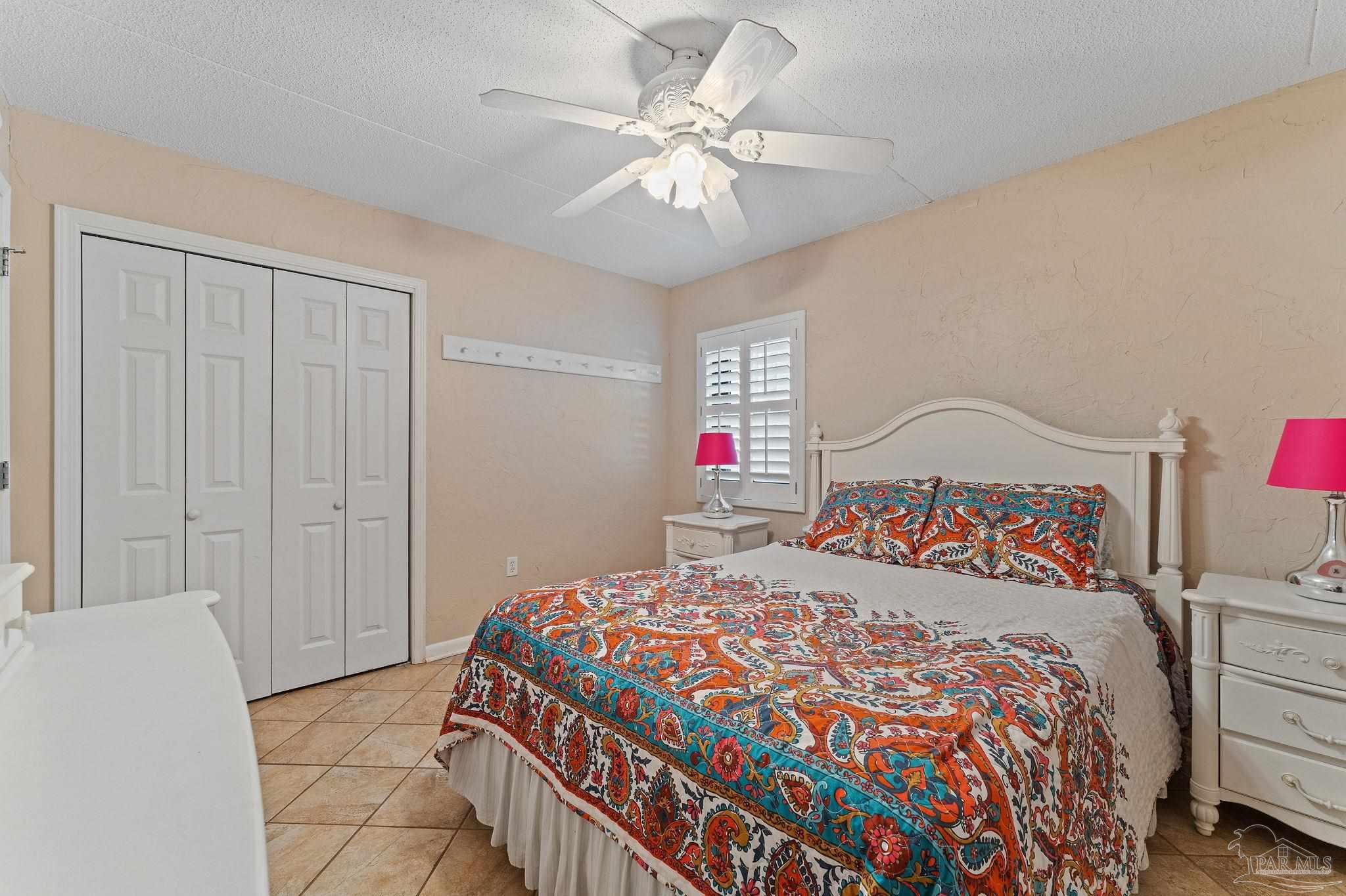 14623 Perdido Key Drive, Unit W106 Perdido Key, FL 32507 - Photo 20 of 50 a bedroom with a bed and a chandelier