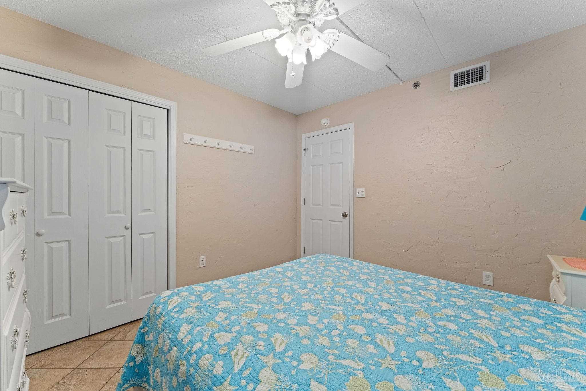 14623 Perdido Key Drive, Unit W106 Perdido Key, FL 32507 - Photo 23 of 50 a bedroom with a bed and a chandelier