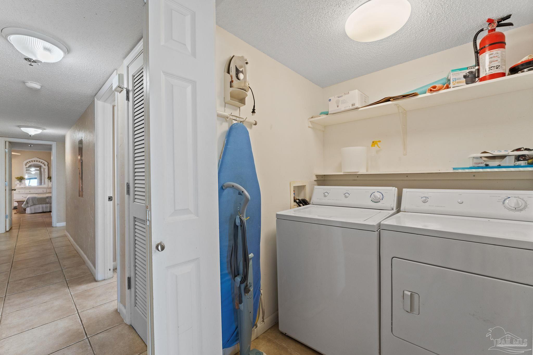 14623 Perdido Key Drive, Unit W106 Perdido Key, FL 32507 - Photo 24 of 50 a view of storage and utility room with washer and dryer