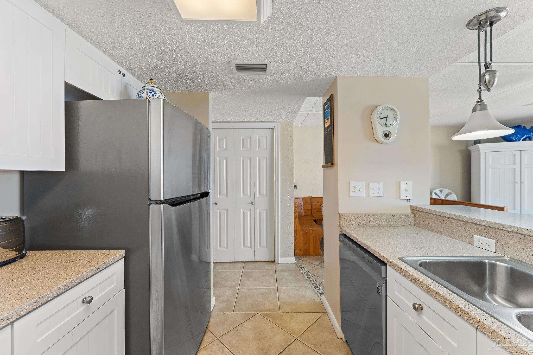 14623 Perdido Key Drive, Unit W106 Perdido Key, FL 32507 - Photo 29 of 50 a kitchen with a refrigerator and a sink