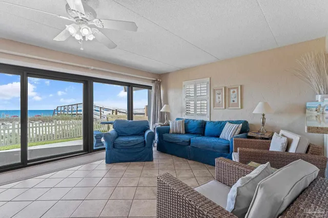 a living room with kitchen island furniture and a chandelier