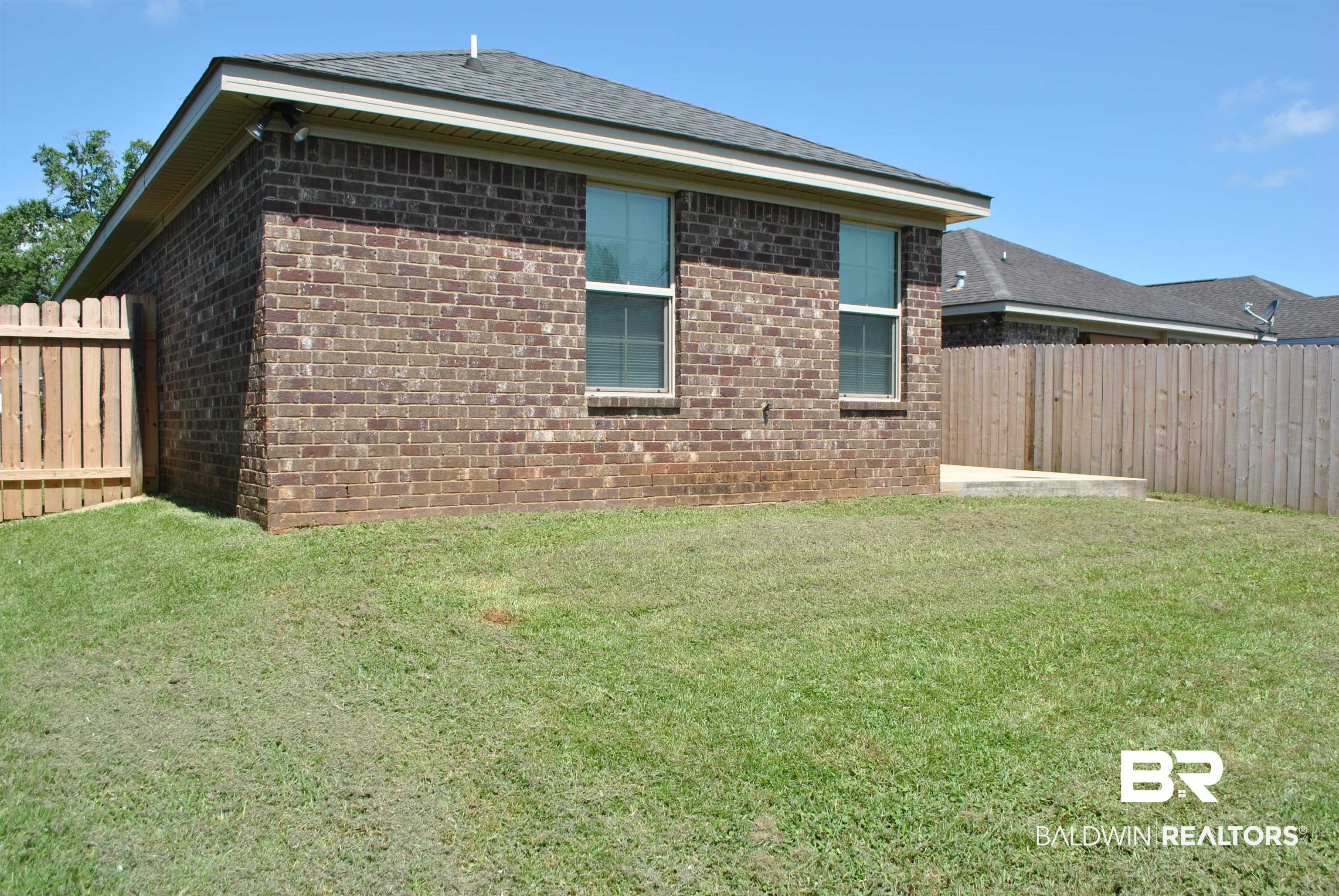 2161 Spring Grove West Mobile, AL 36695 - Photo 29 of 31 View of side of property with a fenced backyard, brick siding, and roof with shingles
