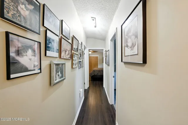 a bedroom with a large bed and flat tv screen on dresser