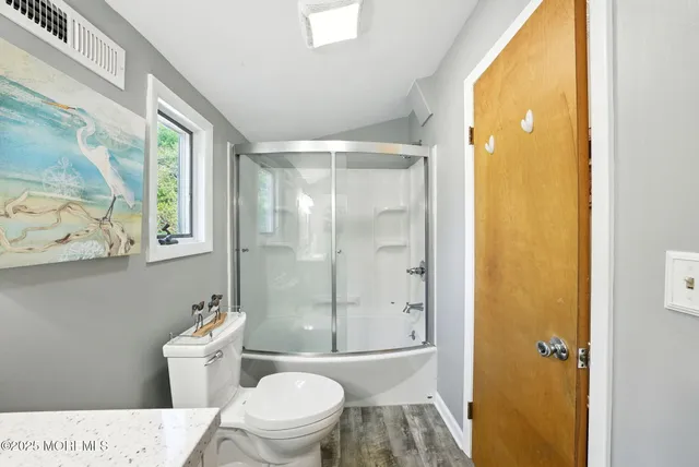 a bathroom with a sink mirror and a bath tub