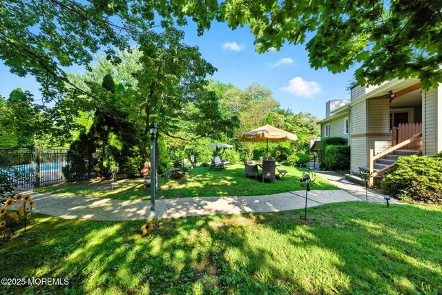 a view of a backyard with sitting area
