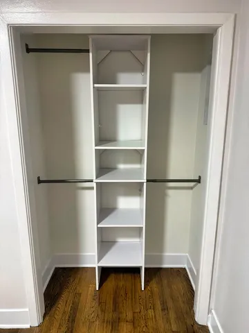 a view of walk in closet with empty racks