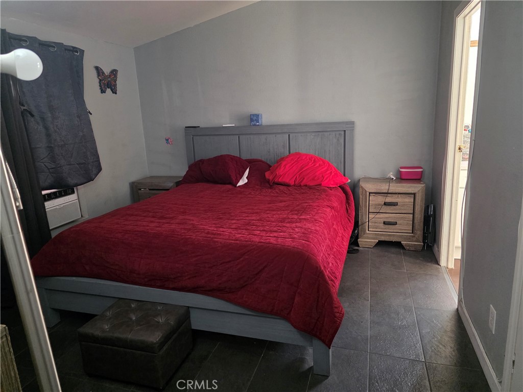 12044 Royal Road, Unit SPC 128 El Cajon, CA 92021 - Photo 7 of 12 a bedroom with a bed and a closet