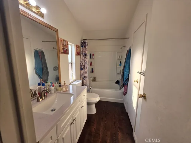 a bathroom with a double vanity sink toilet and shower