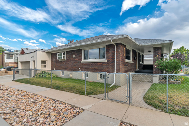 4883 South Center Street Murray, UT 84107 - Photo 29 of 32 Brick-clad exterior with white trim and a contrasting light-colored garage extension