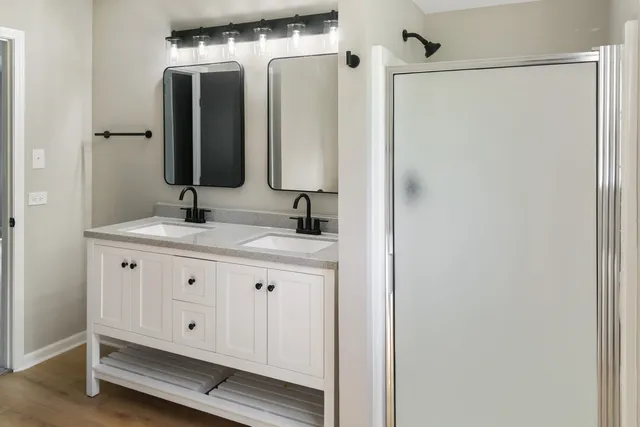 a bathroom with a double vanity sink and a mirror
