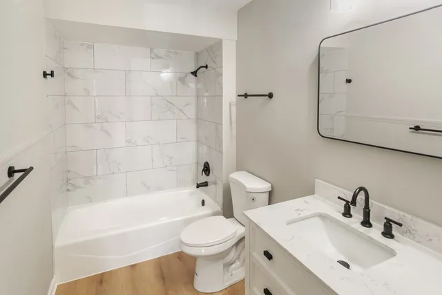 a bathroom with a sink toilet and shower