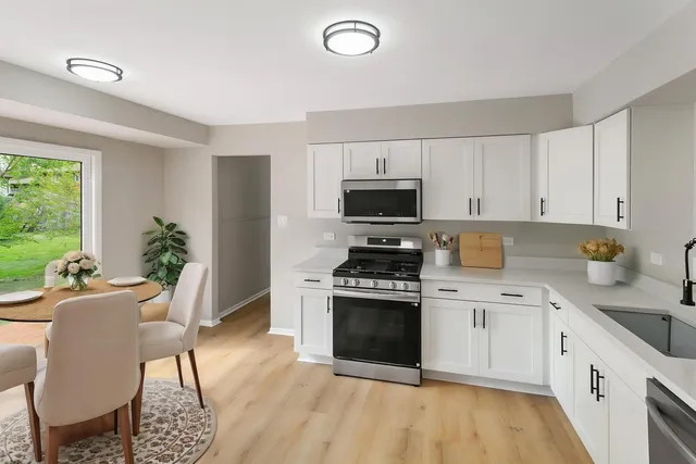 a kitchen with a stove a sink and a refrigerator