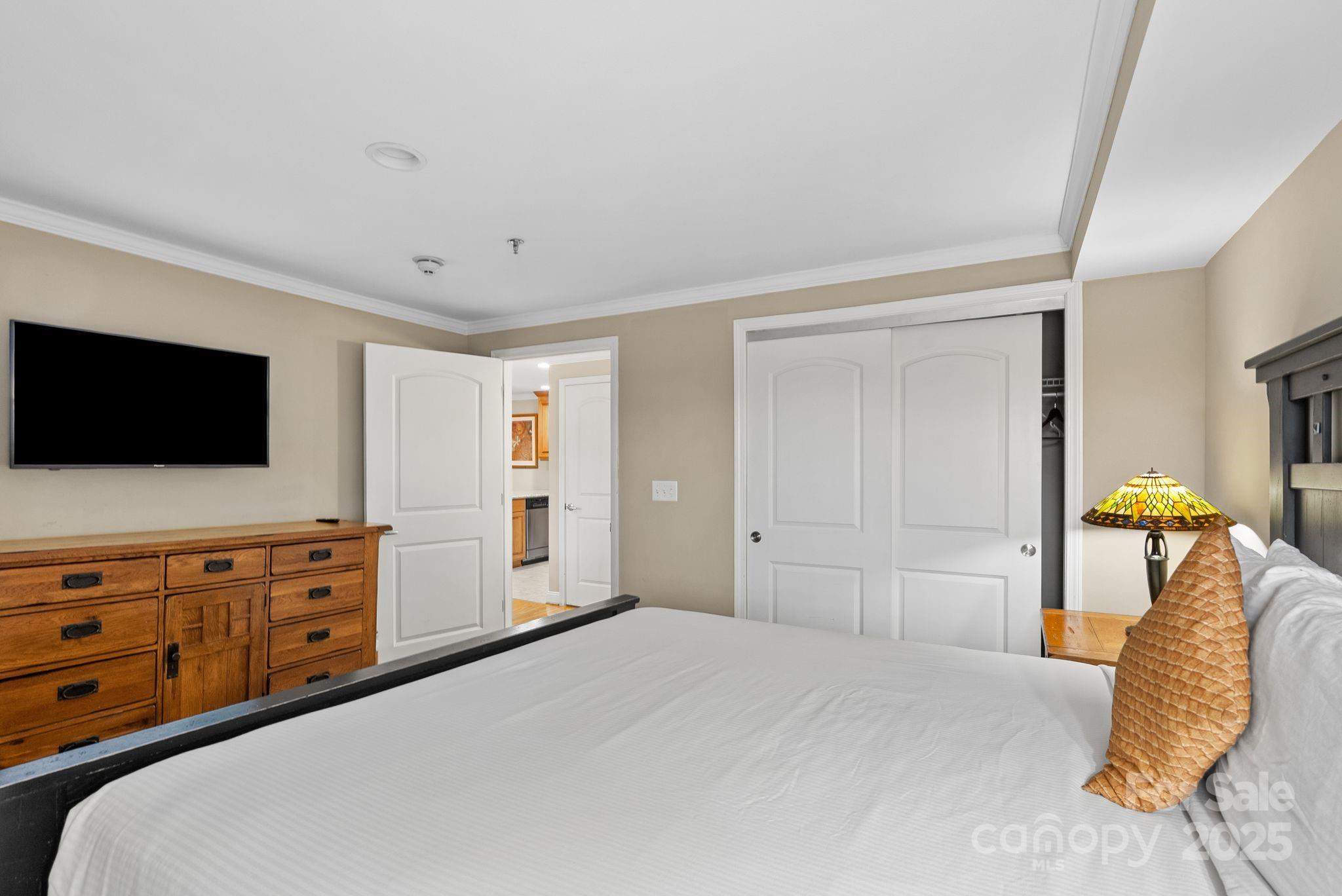 430 Bowling Park Road Asheville, NC 28803 - Photo 12 of 22 a bedroom with a bed and flat screen tv